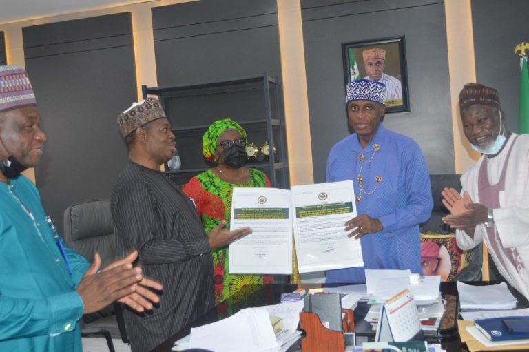 Acting DG of ICRC Michael Ohiani, Presenting the Full Business Case Certificates to the Minister of Transportation Rotimi Amaechi