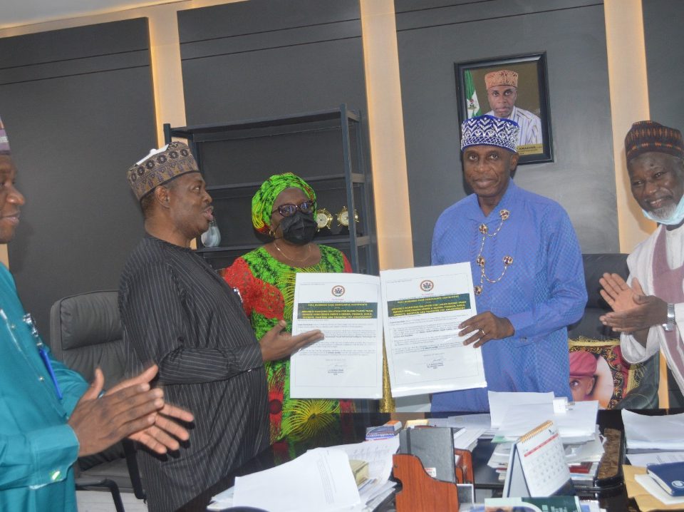 Acting DG of ICRC Michael Ohiani, Presenting the Full Business Case Certificates to the Minister of Transportation Rotimi Amaechi